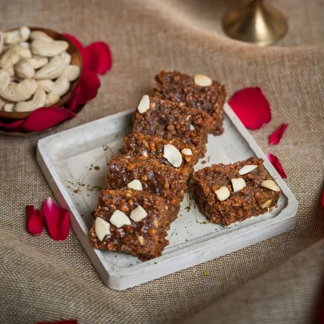 Dark, grainy doda barfi topped with almonds