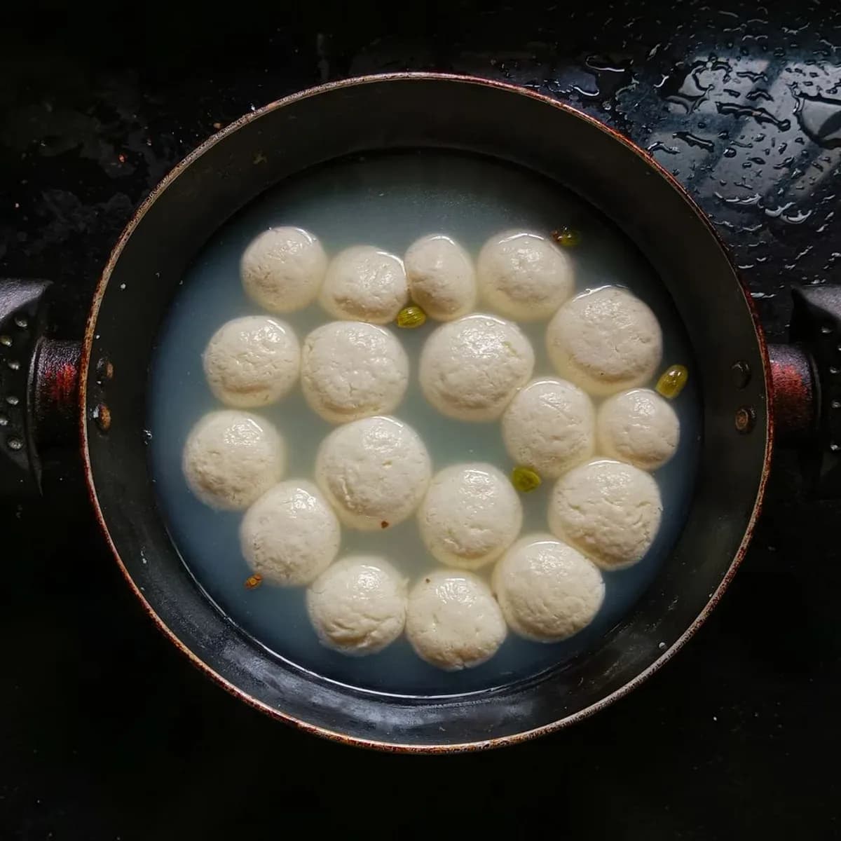 Soft white sponge rasgulla floating in syrup