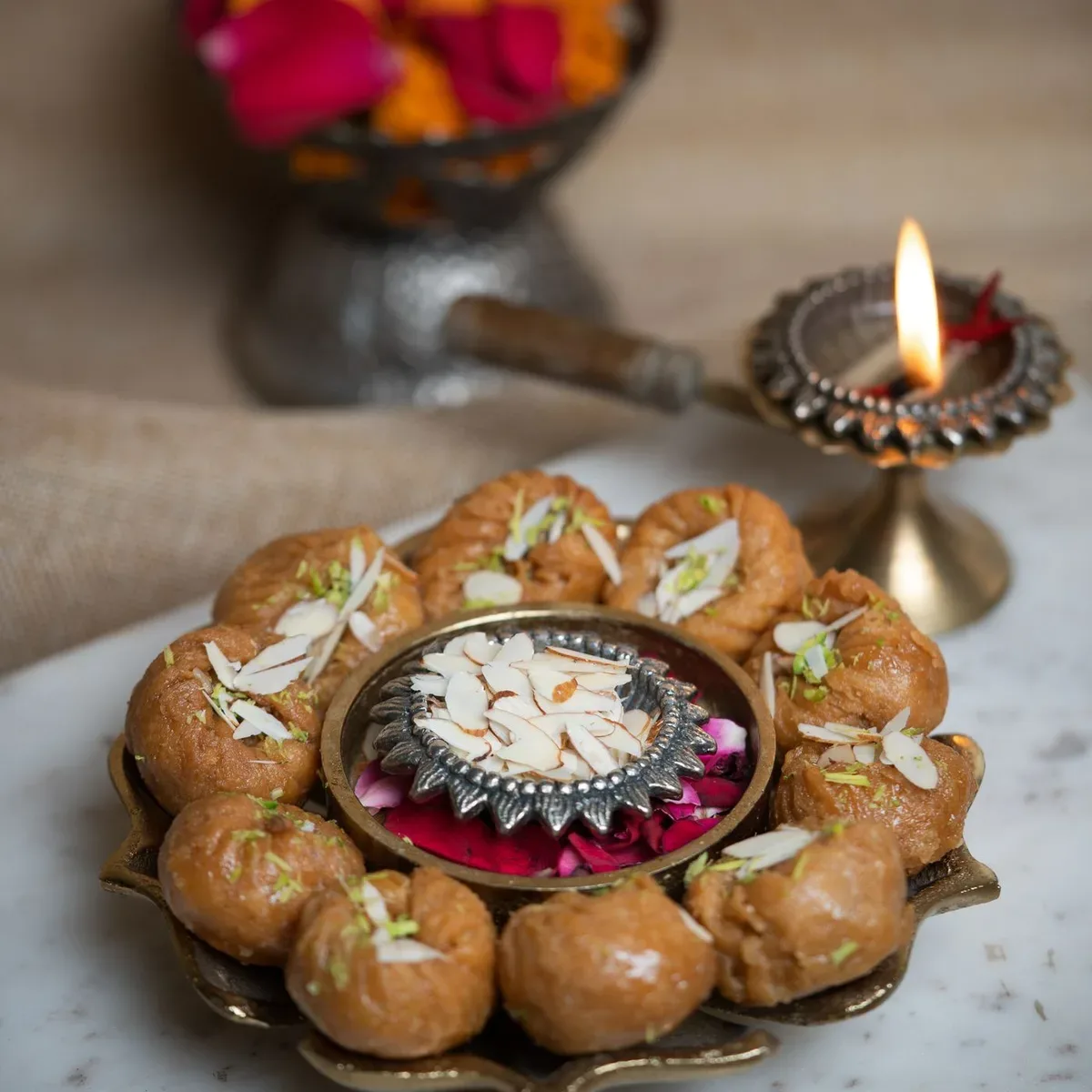 A ring of glazed balushahi on a brass platter